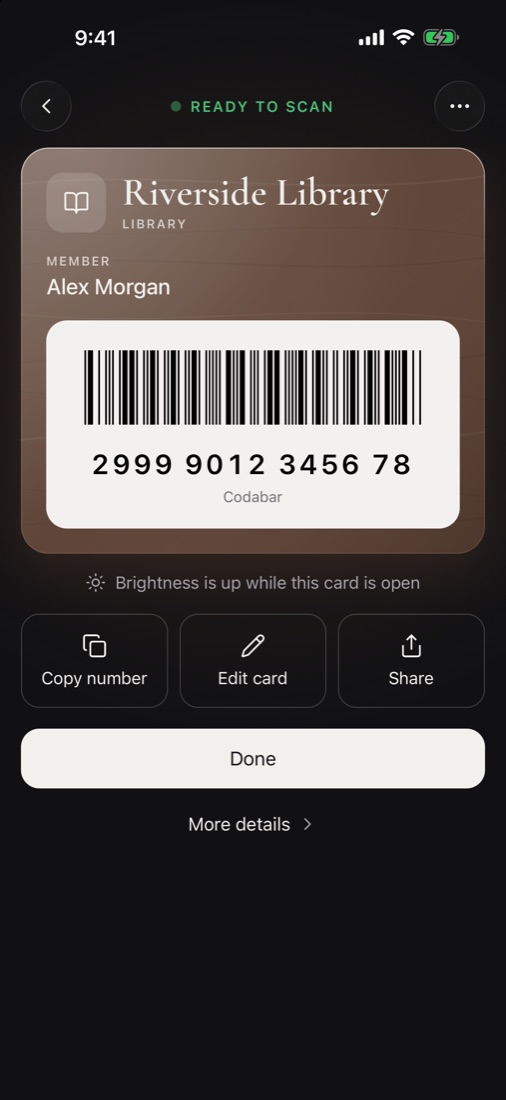 A library card open with its barcode on a bright panel, ready to scan